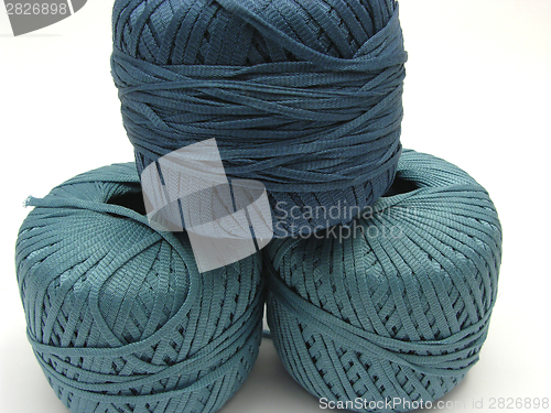 Image of Three stapled  blue wool balls for needlework
