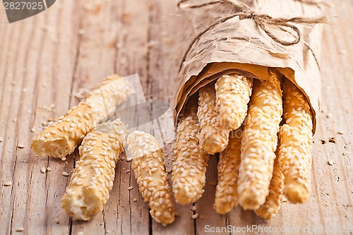 Image of bread sticks grissini with sesame seeds in craft pack