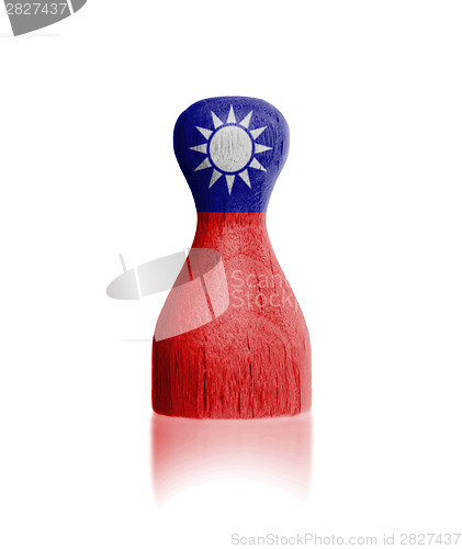 Image of Wooden pawn with a flag painting
