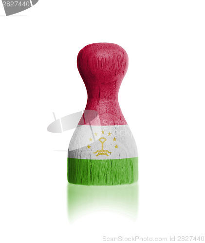 Image of Wooden pawn with a flag painting