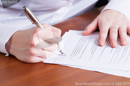 Image of Business lady signing