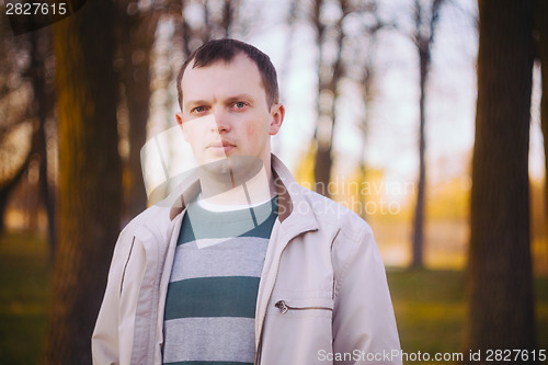 Image of Headshot Of A Young Man Looking At Camera In Park