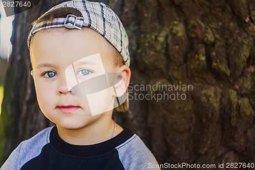Image of Happy child wearing striped cap in outdoor portrait
