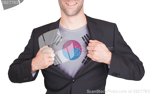 Image of Businessman opening suit to reveal shirt with flag