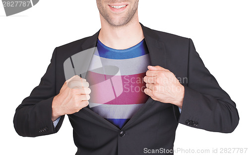 Image of Businessman opening suit to reveal shirt with flag