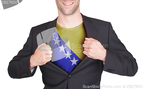 Image of Businessman opening suit to reveal shirt with flag