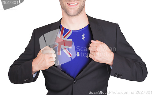 Image of Businessman opening suit to reveal shirt with flag