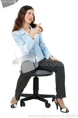 Image of woman points at something sitting on an office chair