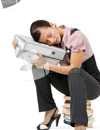 Image of woman sleeping on the books. Tired office worker