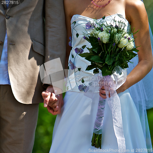 Image of Wedding Couple Standing With Bouquet