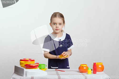 Image of Girl with a plate cake in the kitchen