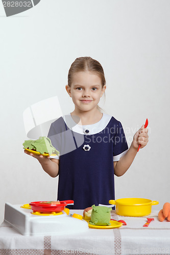 Image of Girl cuts cabbage soup