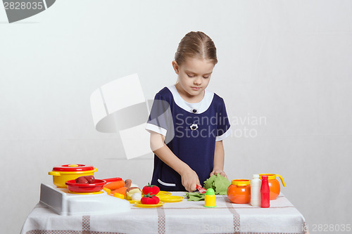 Image of Girl in the kitchen preparing dinner