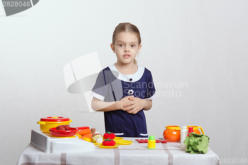 Image of Girl on a toy kitchen