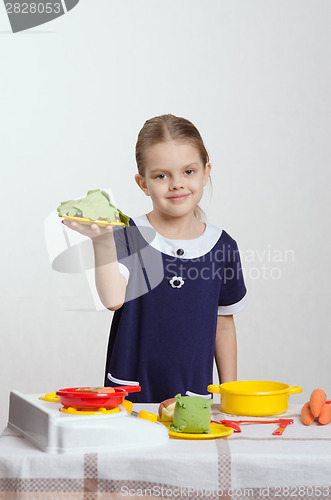 Image of Five year old girl a second dish cooked in kitchen