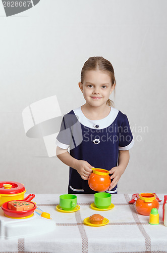 Image of Girl with the children's kitchen utensils