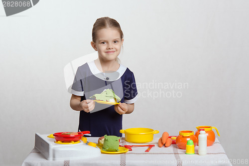 Image of Five year old girl a plate with dish