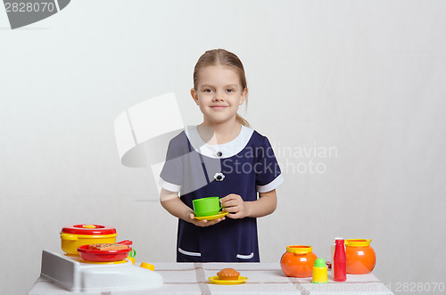 Image of Girl playing toy dishes