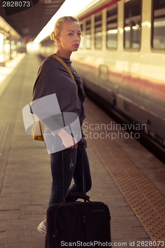 Image of Lady waiting at the railway station.