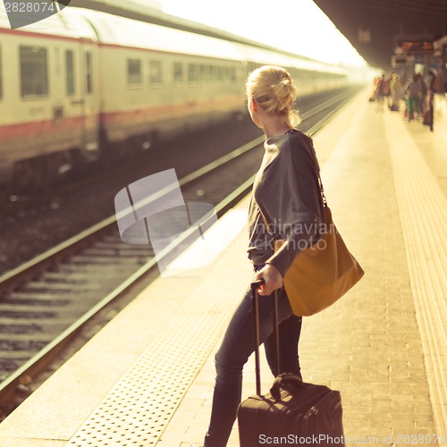 Image of Lady waiting at the railway station.