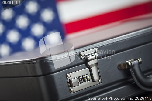 Image of Leather Briefcase Resting on Table with American Flag Behind