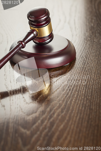 Image of Wooden Gavel Abstract on Reflective Table