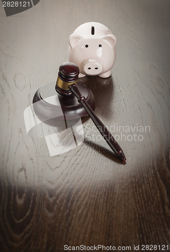 Image of Gavel and Piggy Bank on Table