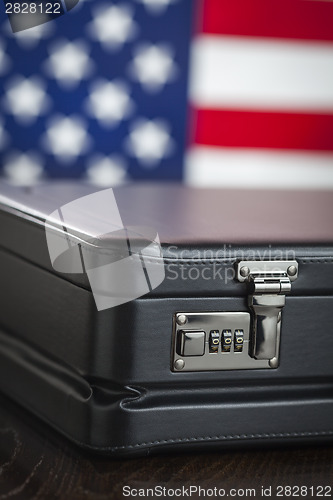 Image of Leather Briefcase Resting on Table with American Flag Behind