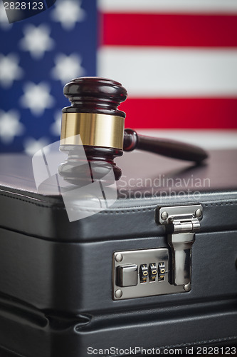 Image of Briefcase and Gavel Resting on Table with American Flag Behind