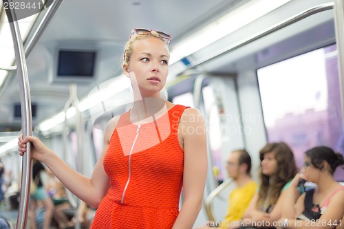 Image of Lady traveling by metro.