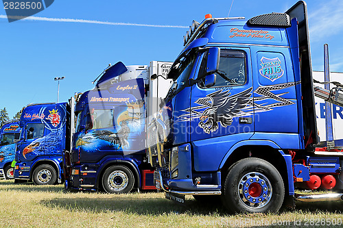 Image of Row of Heavy Trucks with Artwork in a Show