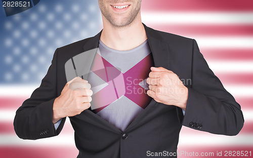 Image of Businessman opening suit to reveal shirt with state flag