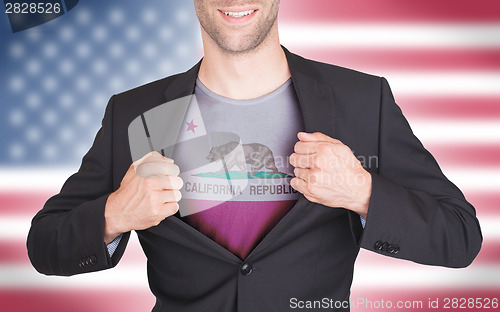 Image of Businessman opening suit to reveal shirt with state flag