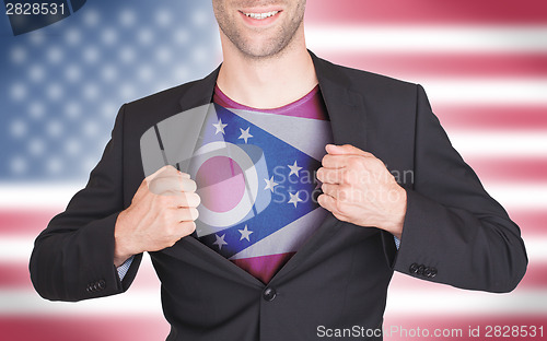 Image of Businessman opening suit to reveal shirt with state flag