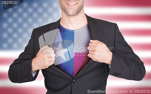 Image of Businessman opening suit to reveal shirt with state flag