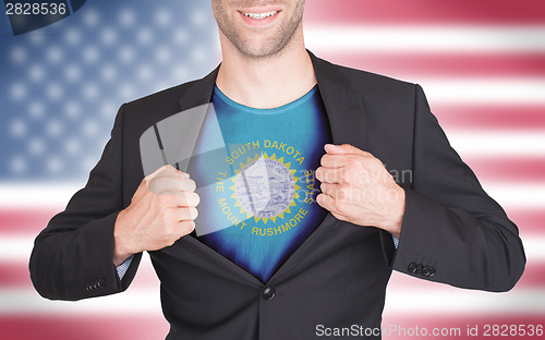 Image of Businessman opening suit to reveal shirt with state flag