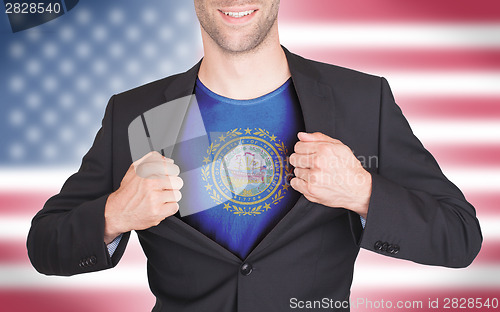 Image of Businessman opening suit to reveal shirt with state flag