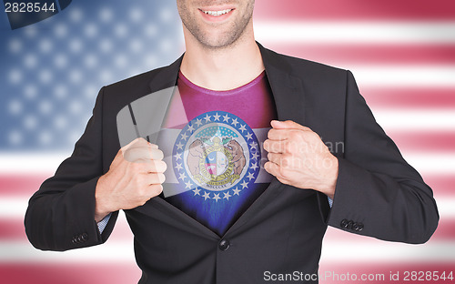 Image of Businessman opening suit to reveal shirt with state flag