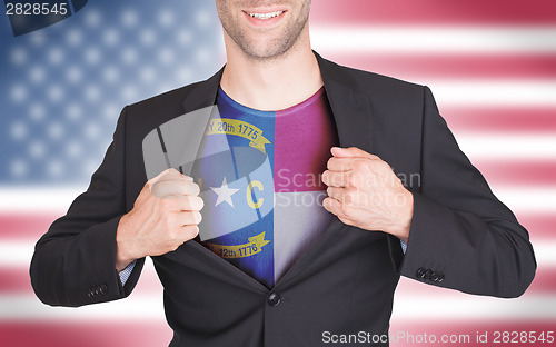 Image of Businessman opening suit to reveal shirt with state flag