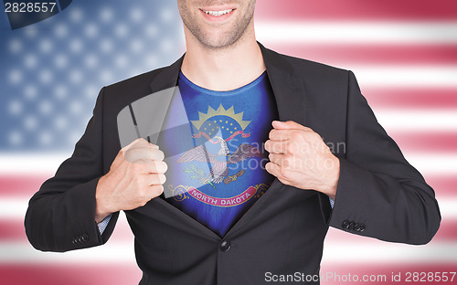 Image of Businessman opening suit to reveal shirt with state flag