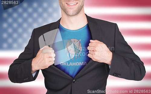 Image of Businessman opening suit to reveal shirt with state flag