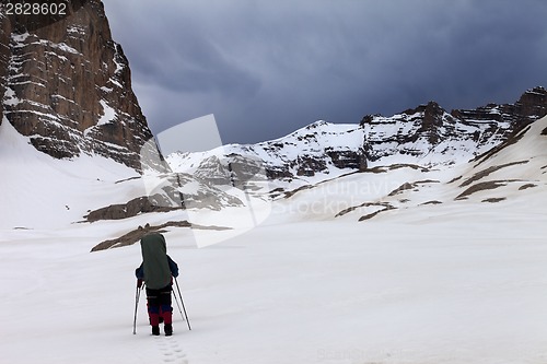 Image of Two hikers at snowy mountains in bad weather