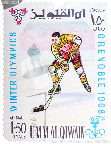 Image of Stamp printed by Umm al-Quwain, shows hockey player bats the puc