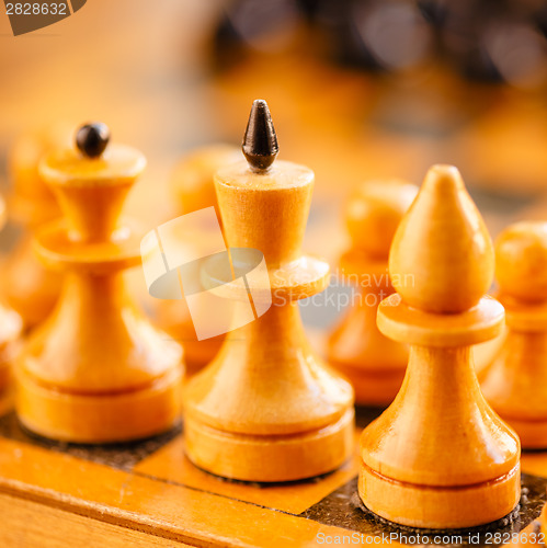 Image of Ancient wooden chess standing on chessboard