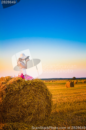 Image of Beautiful Young Girl Woman In Dress Sitting On Haystack