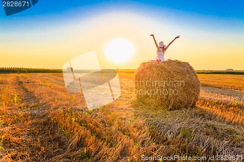 Image of Beautiful Young Girl Sitting On Haystack