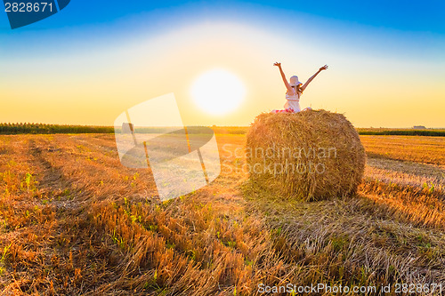 Image of Beautiful Young Girl Sitting On Haystack
