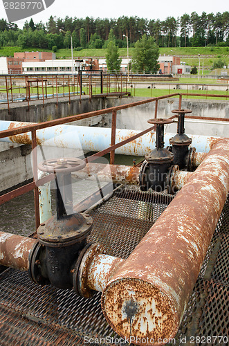 Image of Rusty big taps and pipes. water treatment plant 