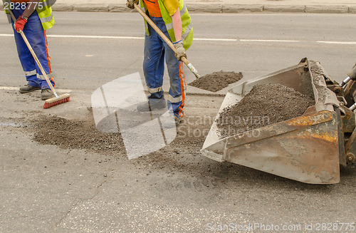 Image of worker operating asphalt during road works 