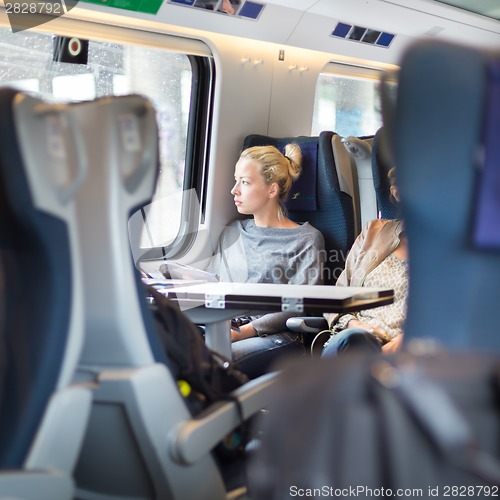 Image of Lady traveling by train.